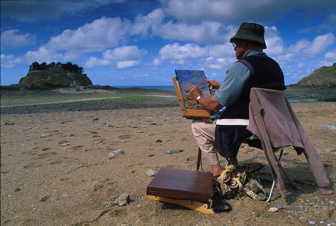 Painter with easel on the beach, Ile de Guesclin, Brittany, France, Europe