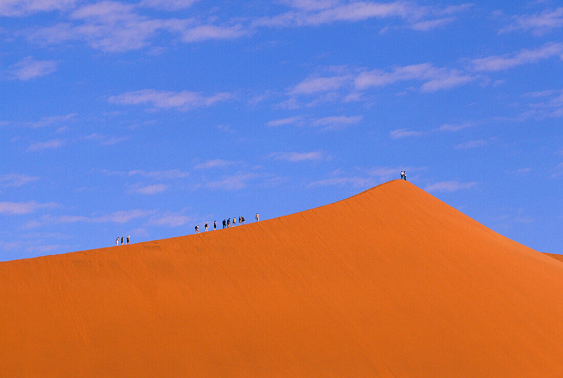 People on a sand dune, Sossusvlei, Namibia, Africa