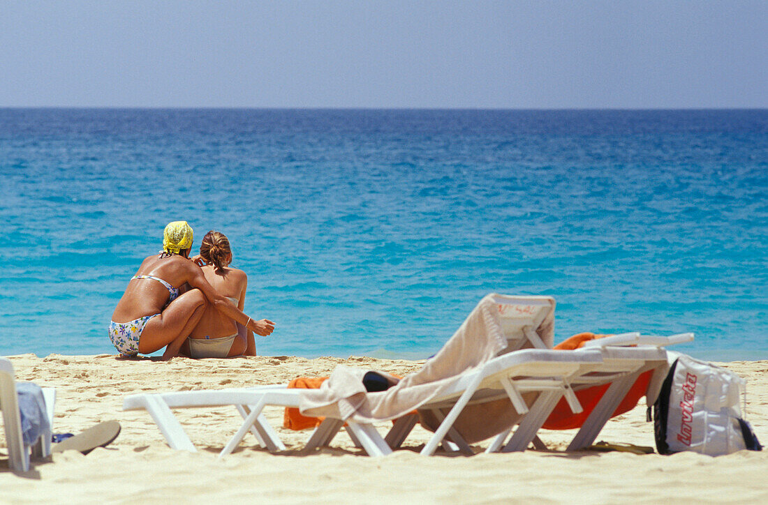 Two woman looking at the sea, Beach of Santa Maria, Sal, Cape Verde Islands, Africa