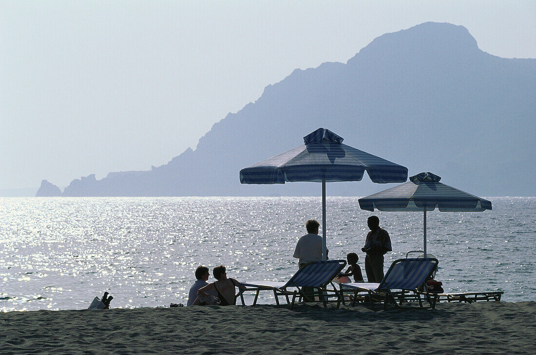 Menschen am Strand unter Sonnenschirmen, Plakias, Kreta, Griechenland, Europa