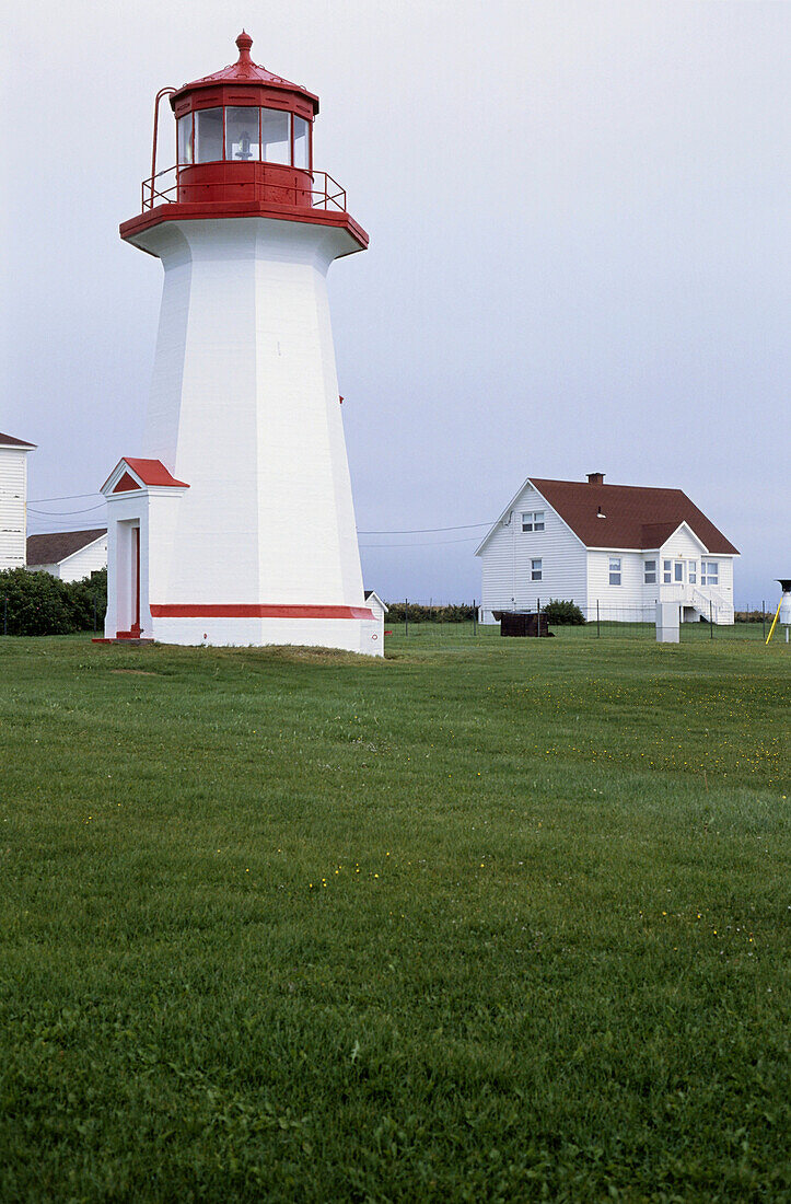 Lighthouse next to houses, Gaspesie, Quebec, Canada