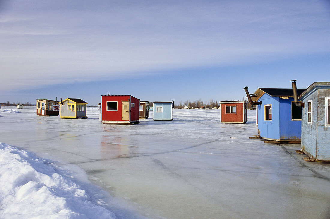 Ice fishing, cabins standing on frozen St. Lawrence River, Quebec, Canada