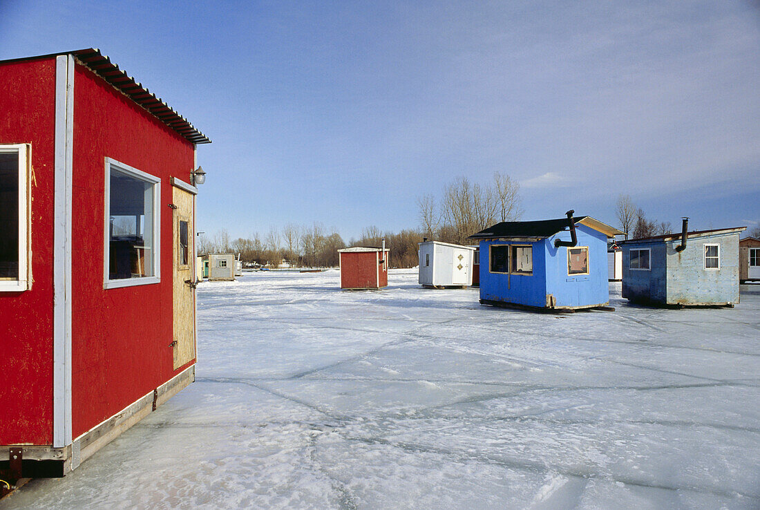 Ice fishing, cabins standing on frozen St. Lawrence River, Quebec, Canada