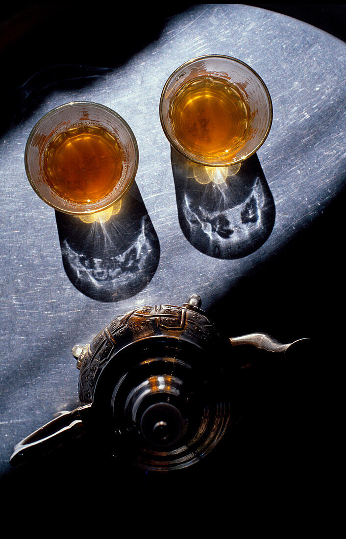 Glasses of tea and a tea pot in a beam of light, Marocco, Africa