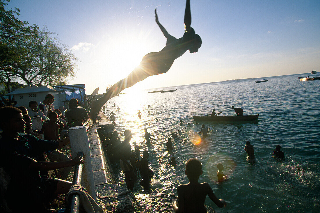 Children and Teenagers bathing at Zanzibar harbour, Tanzania, Africa