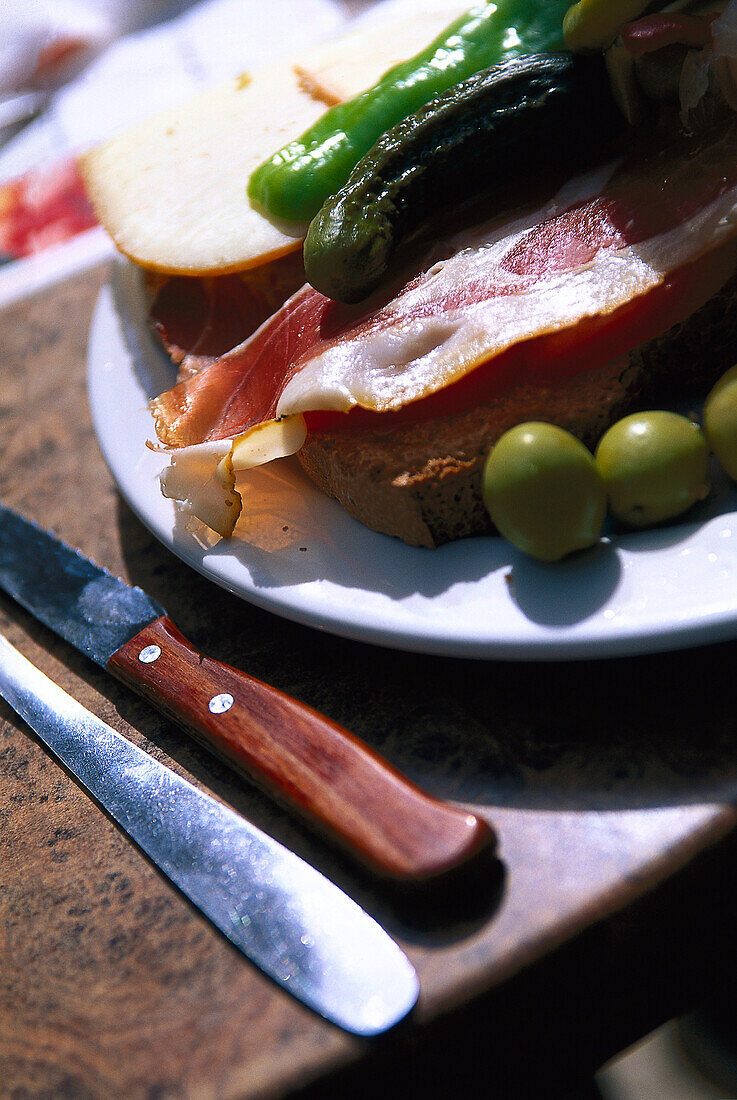Bread with Serrano ham and olive oil on a plate, Majorca, Spain, Europe