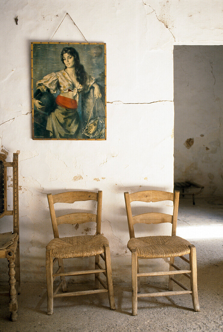 Chairs and a picture in the farm worker's room of a finca, Majorca, Spain