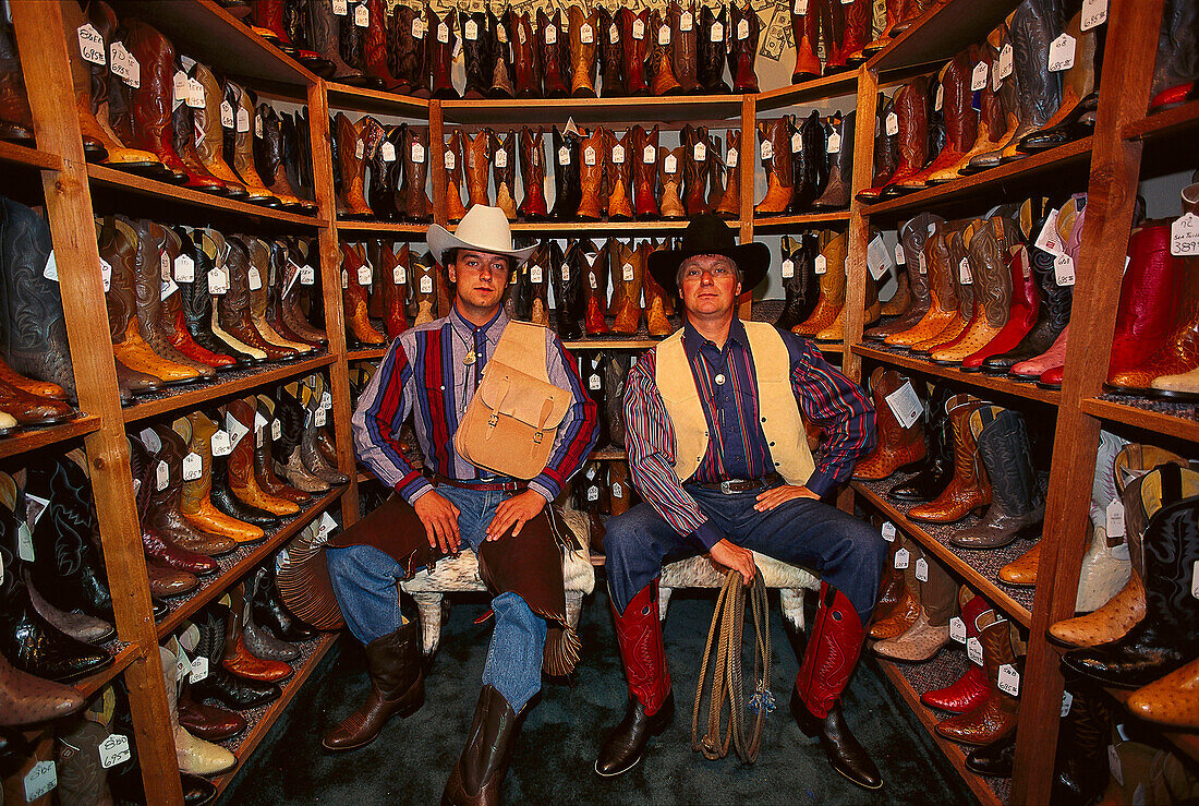 Two men wearing cowboy hats in a shop with cowboy boots, Fort Worth, Texas, USA, America
