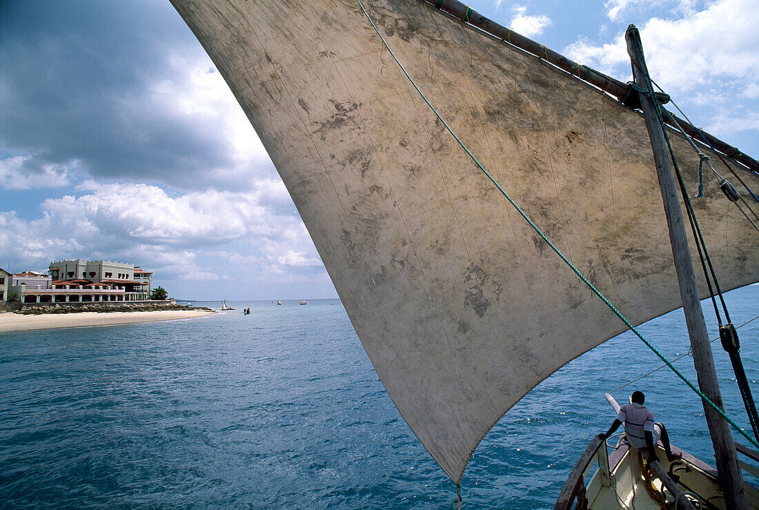 Segel eines traditionellen Handelsschiffs, im Hintergrund Hotel Serena, Stone Town, Sansibar, Tansania, Afrika