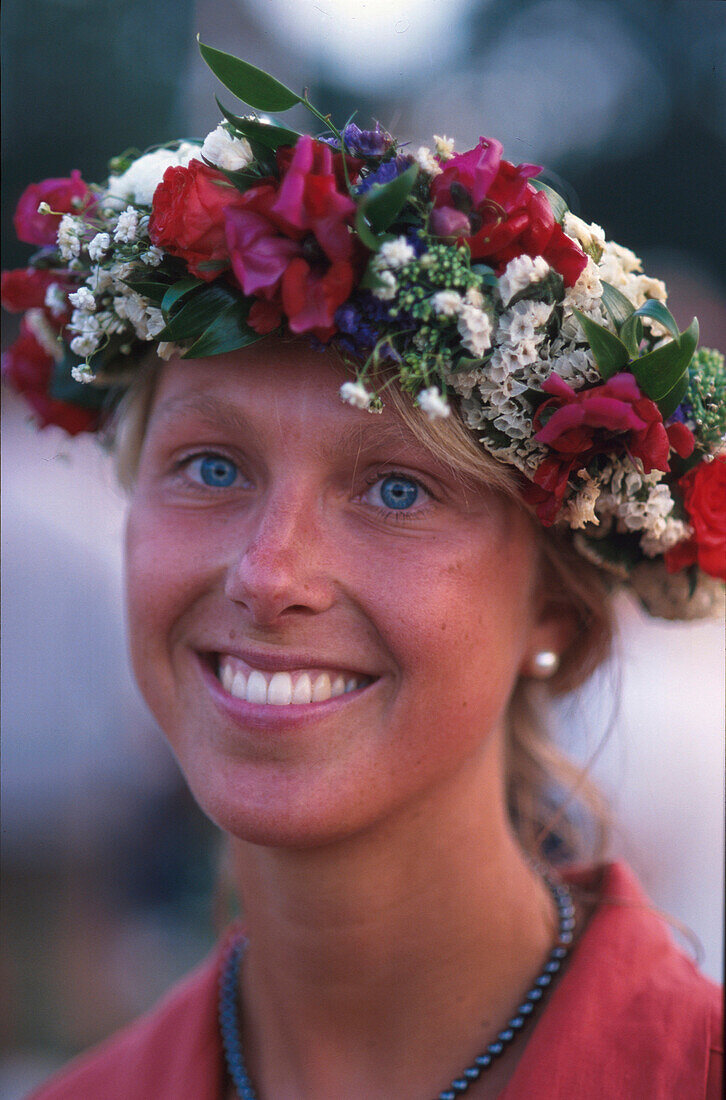 Young woman with floral wreath, Visby, Gotland, Sweden, Europe
