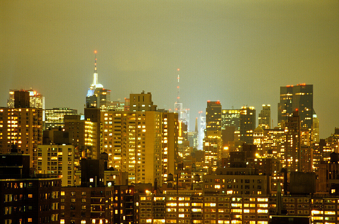 Illuminated high rise buildings at night, Manhattan, New York, USA, America