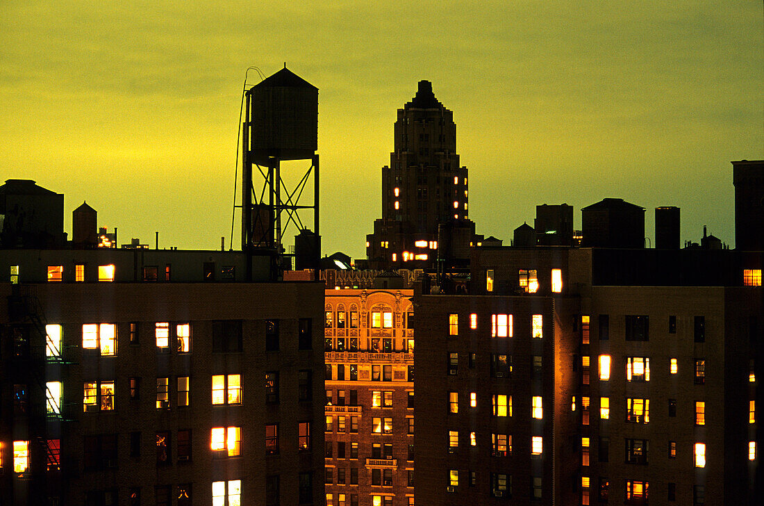 Water tower and high rise buildings at night, Manhattan, New York, USA, America