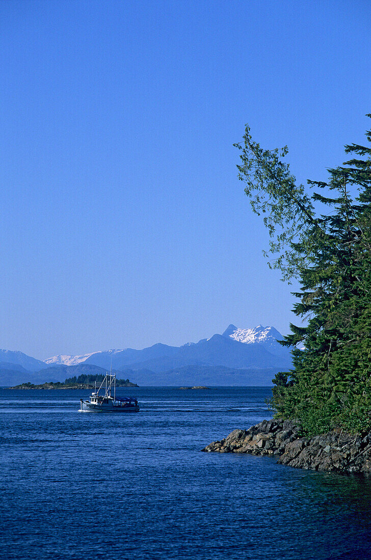 Boat and coast area under blue sky, Telegraph Cove, Vancouver Island, British Columbia, Canada, America