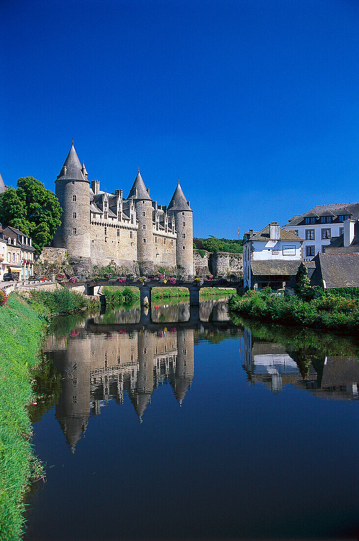 Chateau Josselin at a canal under blue sky, Morbihan, Brittany, France, Europe