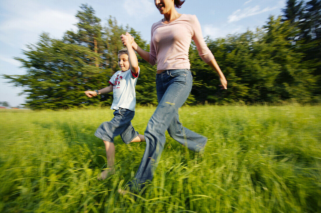 Women with boy running in nature, Women with boy running in nature, Mother with son running through meadow, People Lifestyle Nature Family