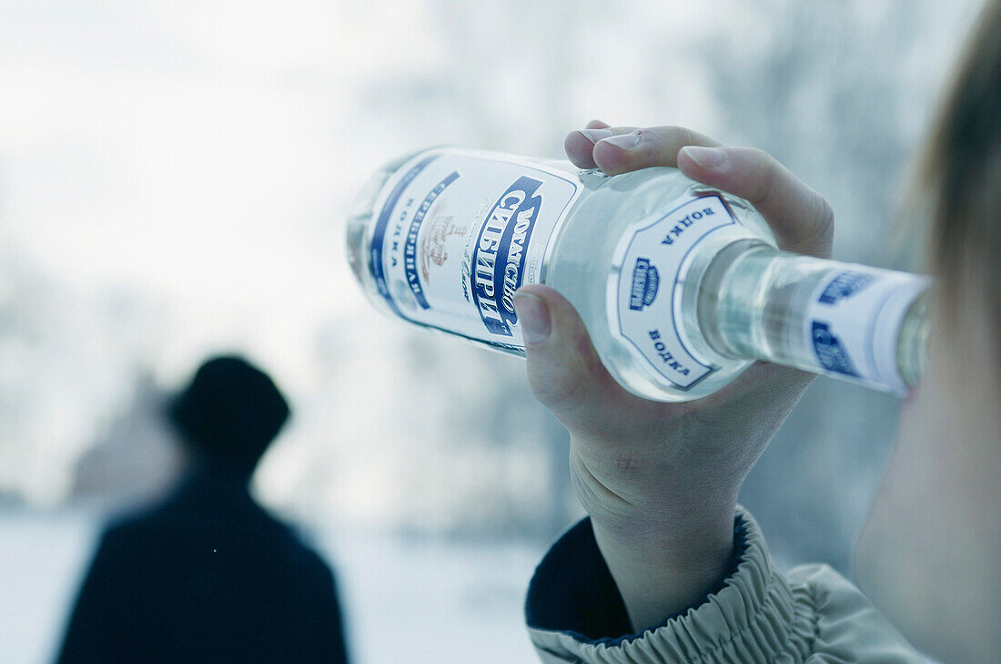 Ein Mann trinkt Wodka aus der Flasche, Omsk, Sibirien