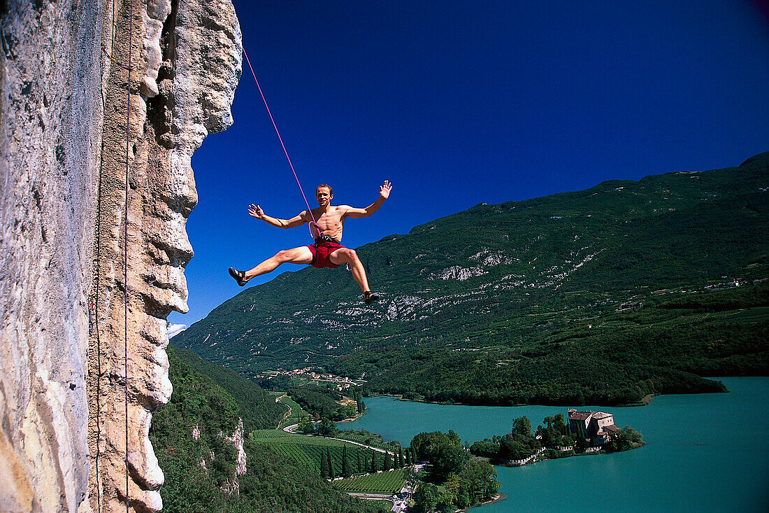 Mann abseiling, Freeclimbing above Lake Garda, Arco, Trento, Italy