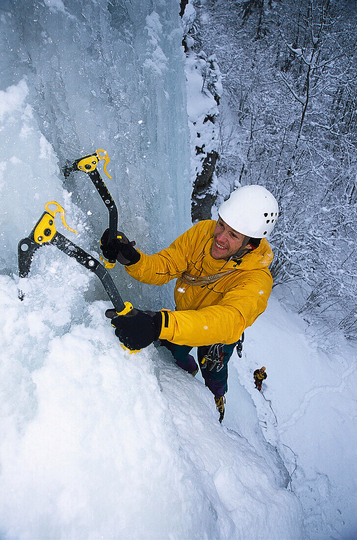 Man climbing up ice fall, Unterlaussa, Upper Austria, Austria