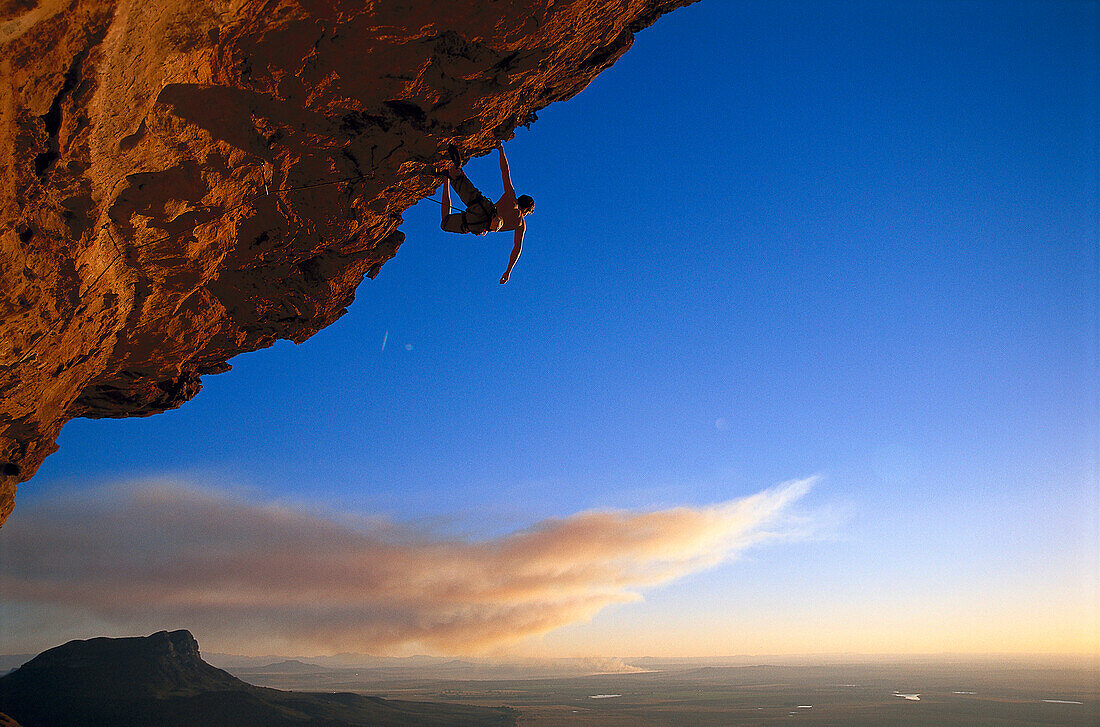 Man doing freeclimbing at overhang, South Africa