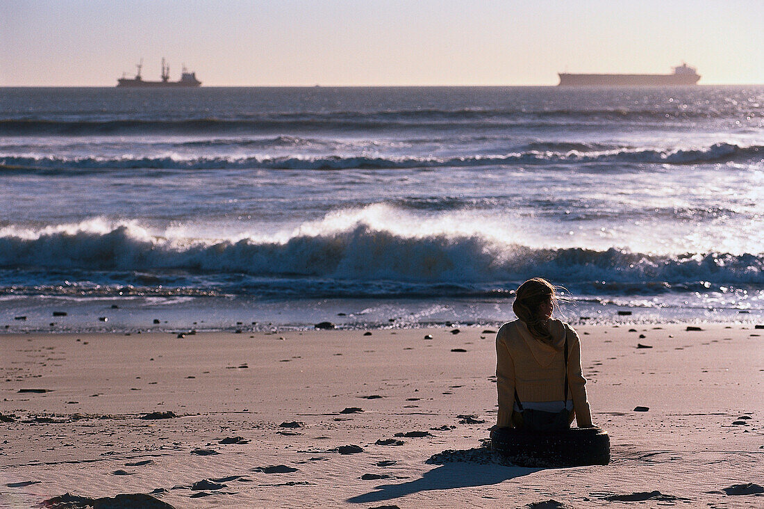 Woman is sitting on the Beach, South Africa