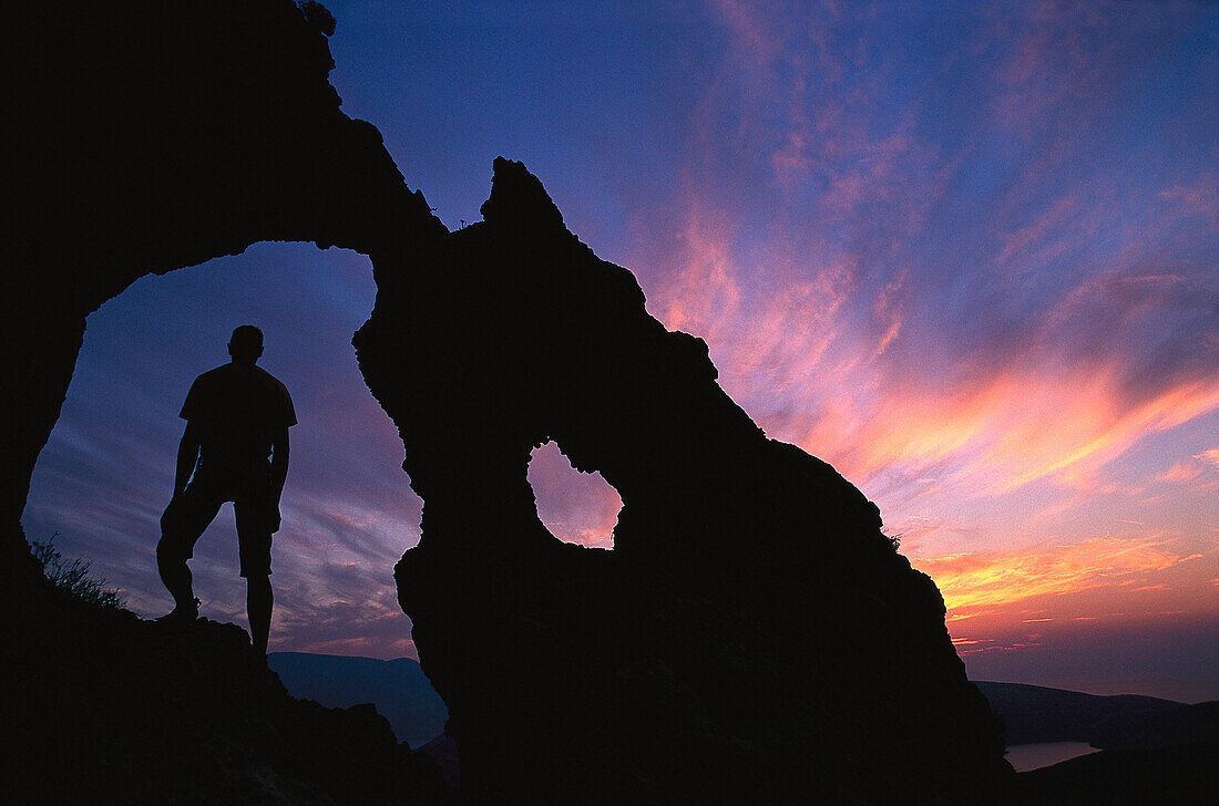 Silhoutte of a man at a rock formation, Kalymnos, Dodecanese, Greece