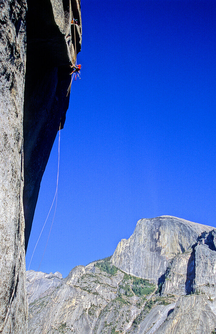 man sbseiling above South West Face, Big Wall Climbing, Washington Column, Yosemite Valley, California, USA