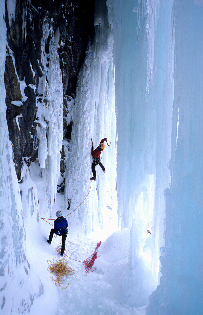 Couple climbing in an ice cave, Golden Area, Banff National Park, Canada