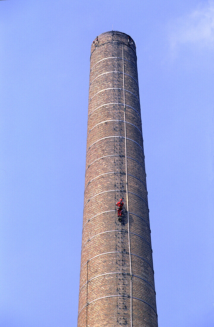 Worker climbing up factory chimney, Renovattion works on factory, Lower Austria, Glanzstoff Fabrik, St. Pölten, Niederösterreich