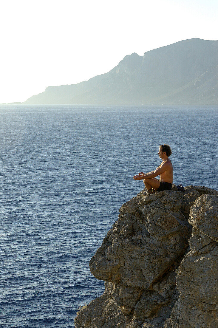 Yoga on cliff line of Kalymnos, Kalymnos, Greece