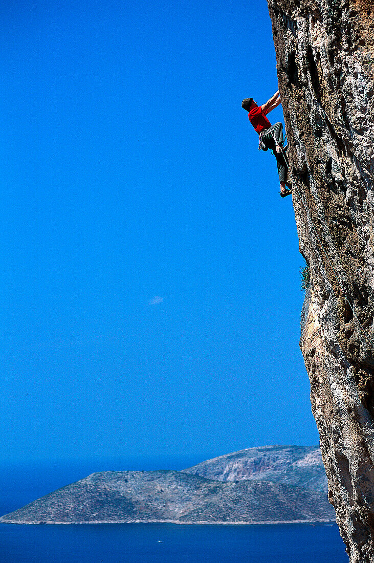 Sepp Hack rock climbing, climbing up a steep rock face, Freeclimbing, Kalymnos, Dodekanes, Greece