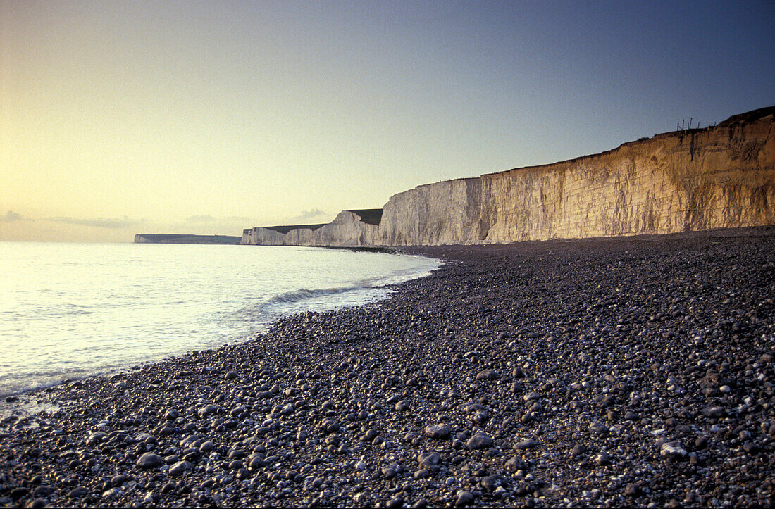 Deserted beach and chalk cliff at sunset, Burling Gap, Downs, East Sussex, England