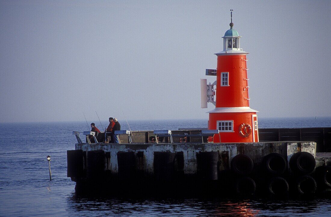 Anglers and lighthouse at harbour of Helsingor, Zealand, Denmark, Europe