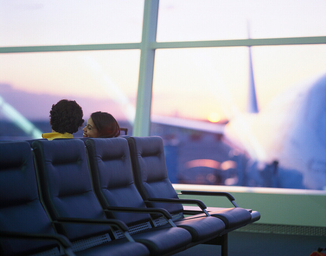 Couple in weiting area, JFK Int. Airport, New York City, USA