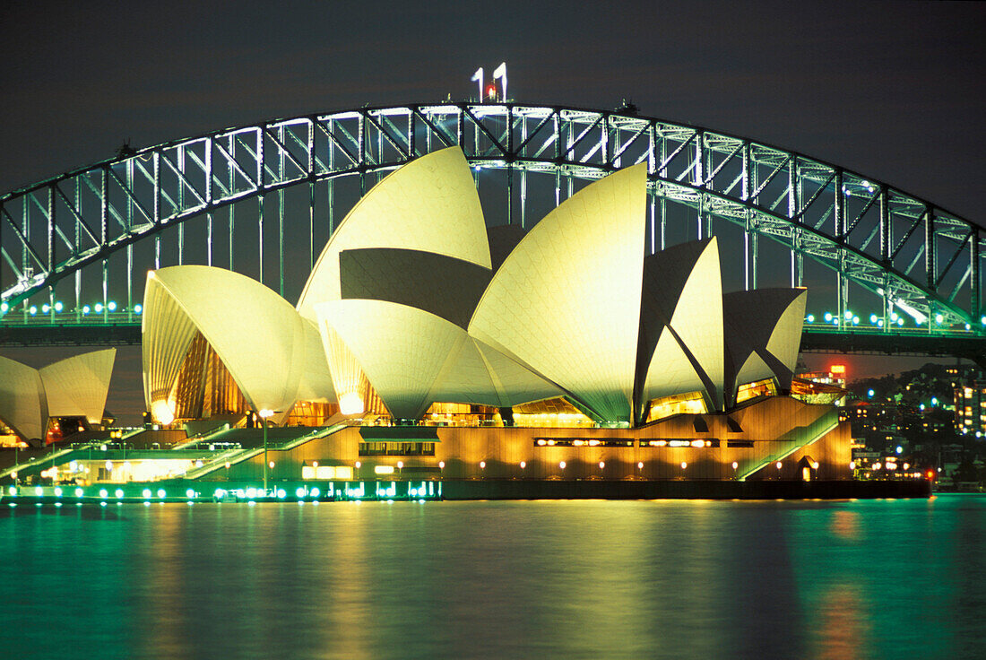 The illuminated Opera House and Harbour Bridge at night, Sydney, New South Wales, Australia