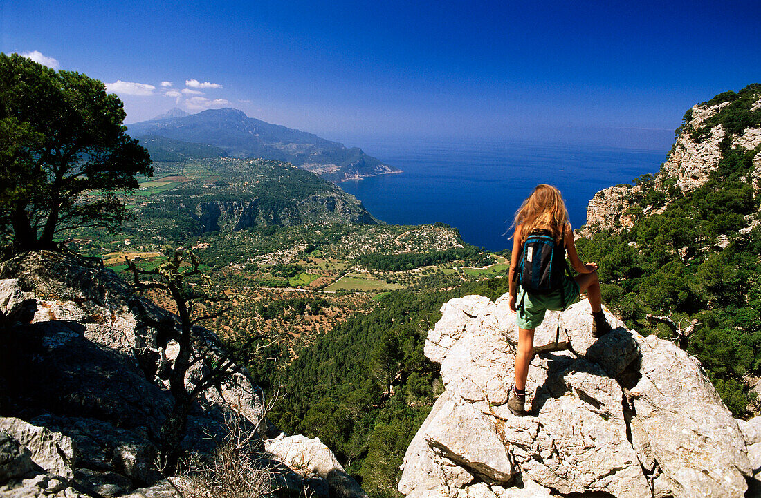 Woman looking at view on bridleway of archduke, Serra de Tramuntana, Majorca, Spain