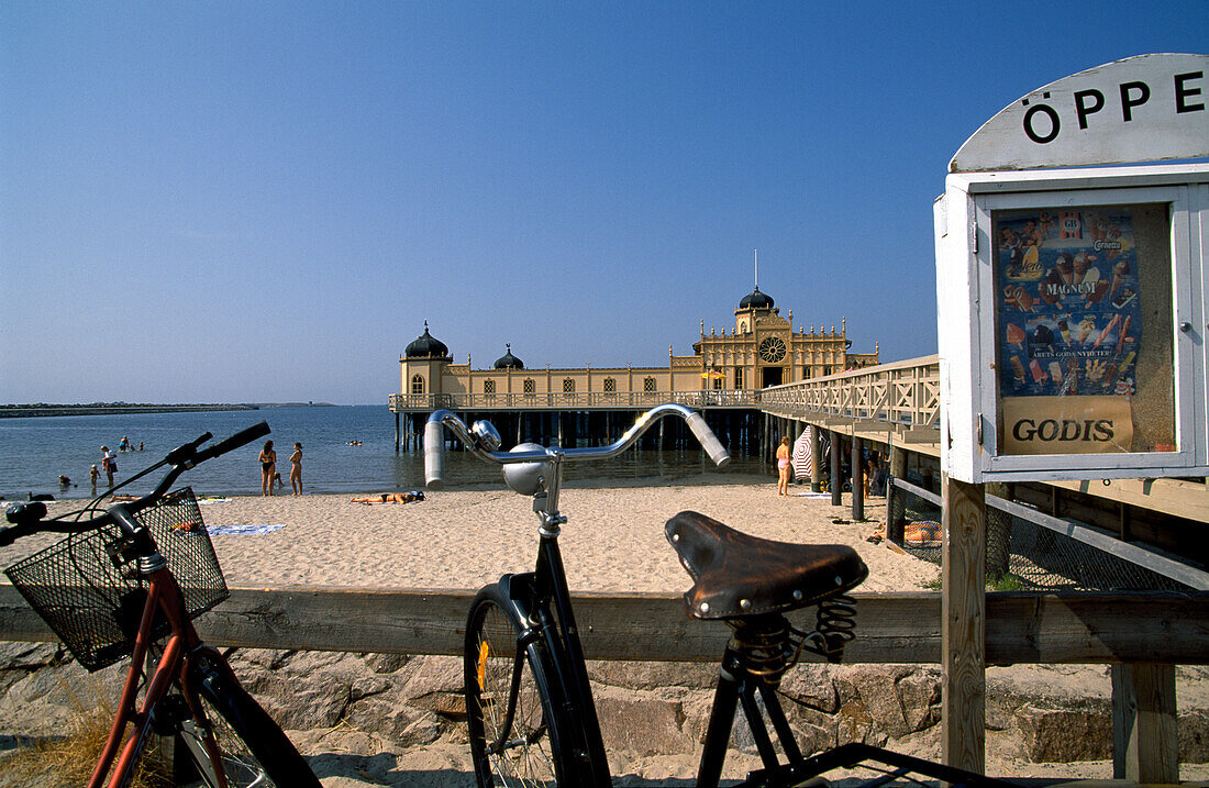 Bikes parked at the beach in front of the Bath House, Kallbadhuset, Varberg, Halland, Sweden