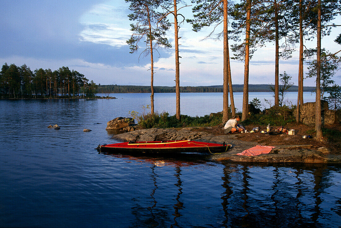 Kayaktour, woman sitting on island, Lake Stora Gla, south of Arvika, Varmland, Sweden