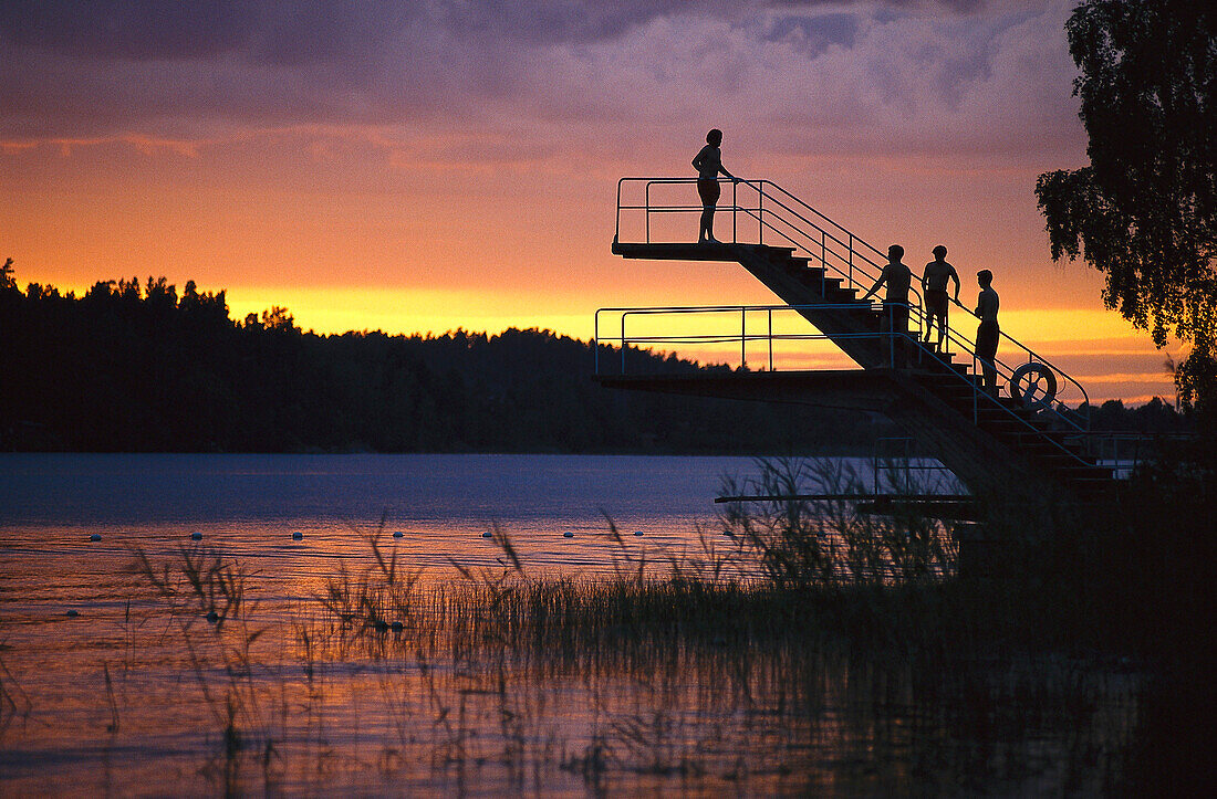 Boys on diving platform at lake, Kattnas near Gnesta, Sodermanland, Sweden