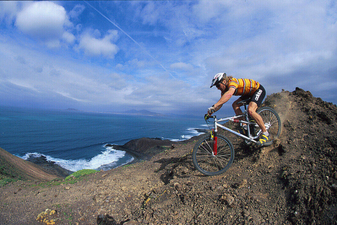 Man mountain biking, on a mountain bike tour, MTB tour, Fuerteventura, Canary Islands, Spain