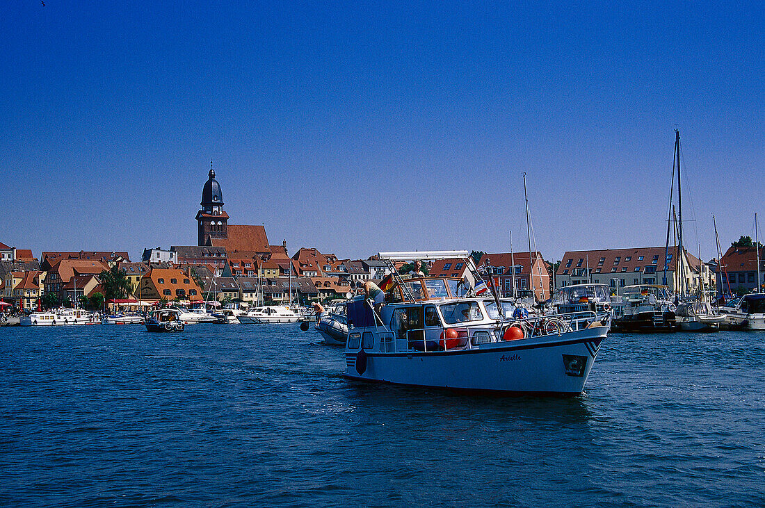 Motor boat in a harbour, Lake Mueritz, Mecklenburg lake district, Mecklenburg-Vorpommern, Germany