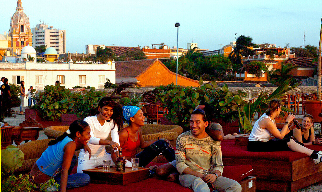 Laughing people on the terrace of the Cafe del Mar, Cartagena de Indias, Colombia, South America