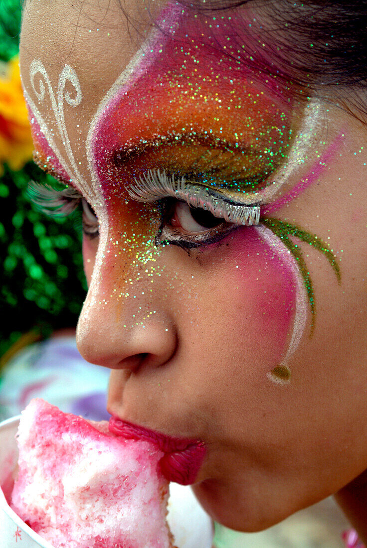 Painted girl eating ice cream, Baranquilla, Colombia, South America