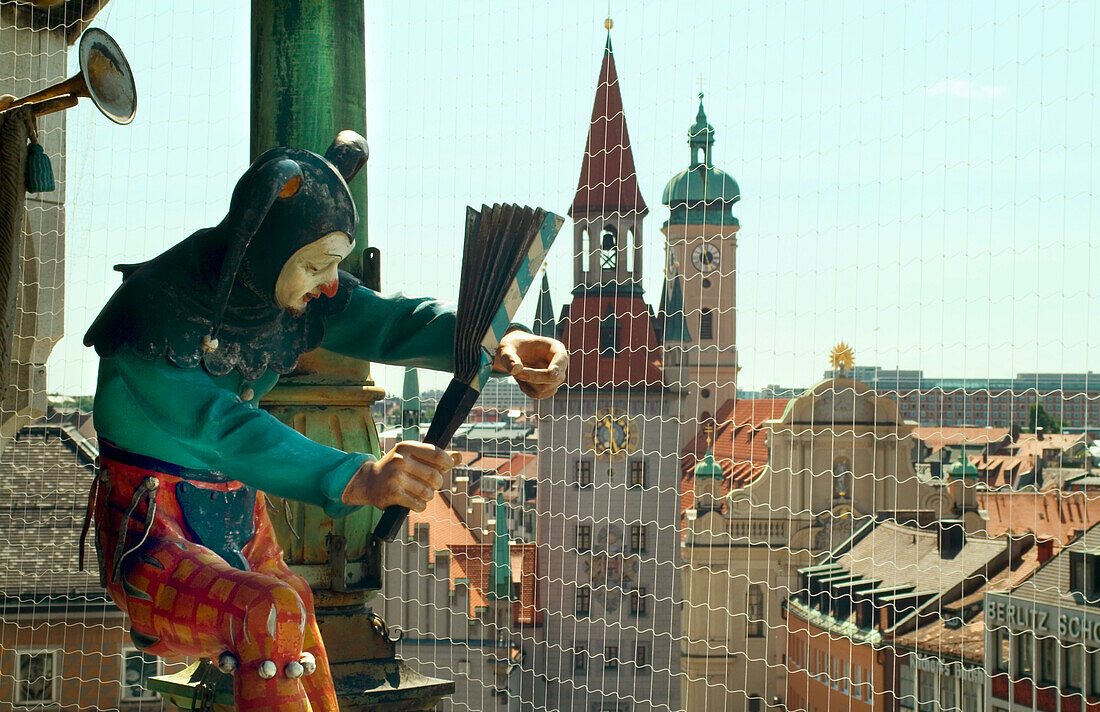 Glockenspiel am Rathausturm, Juggler figure at Town Hall Tower carillon, Marienplatz, Munich, Bavaria, Germany, Chiming Clock in the New Town Hall, Colored Dancers and Knights act out an event of Munich´s Past – the tounament held on Marienplatz in 1568 f