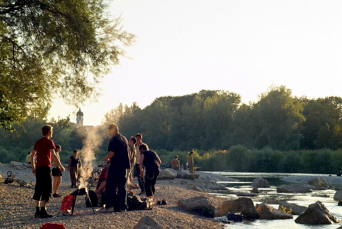 People, barbecueing and picnicing at Isar River, Sendling, Munich, Bavaria, Germany