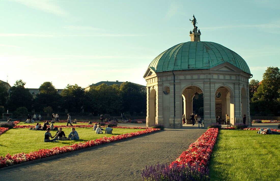 People sitting in front of Pavillon, 17th century, Hofgarten, Munich, Bavaria, Germany