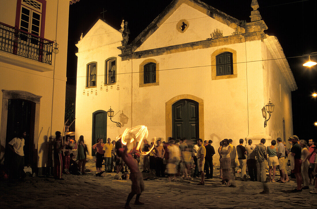 Spectators watching fire-eater, Paraty, Rio de Janeiro, Brazil