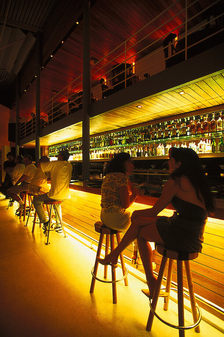 People at the illuminated counter of the Cafe Concerto, Rua das Pedras, Armacao, Buzios, Brazil, South America, America