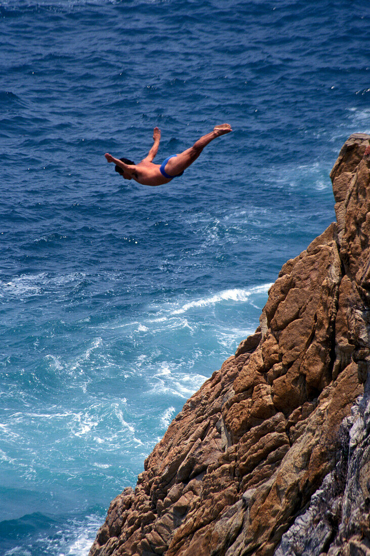 Cliff diver during jump, Acapulco, Guerrero, Mexico, America
