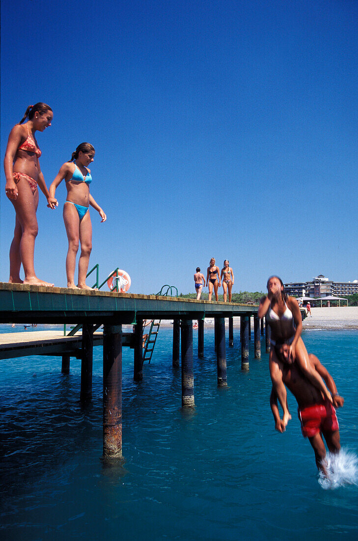 Young people on the wooden footbridge, Hotel Xanadu, Belek, Turkish Riviera, Turkey