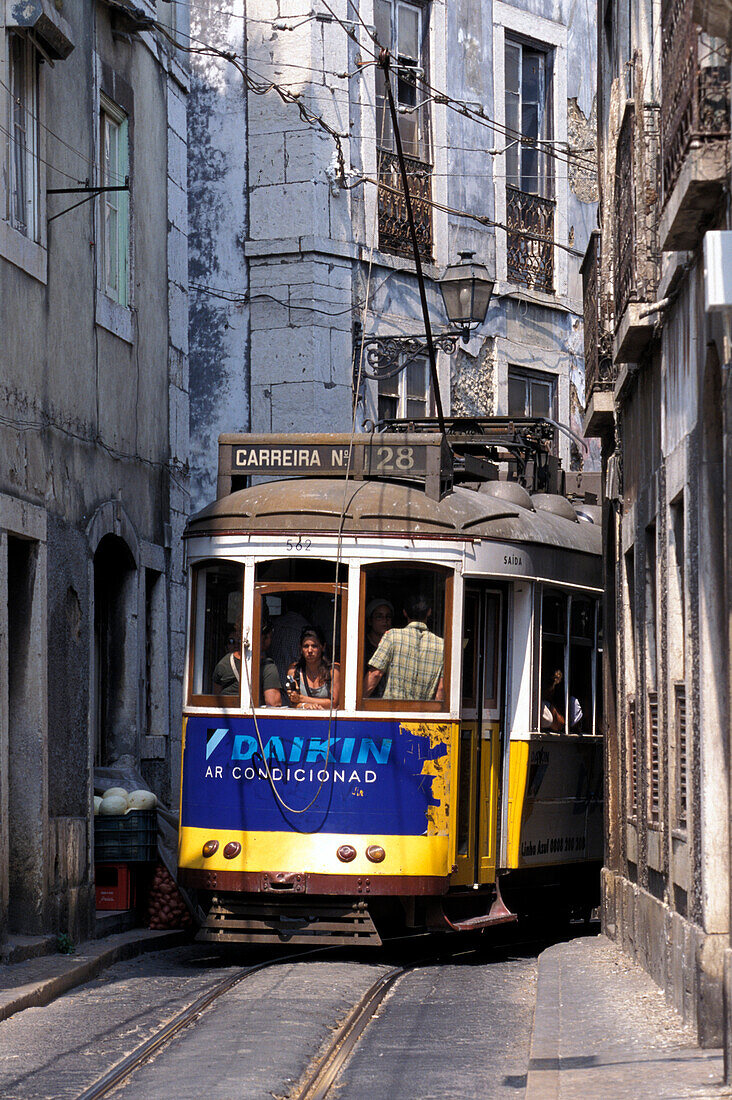 Tram in a narrow alley, Electrico 28, Alfama, Lisbon, Portugal, Europe